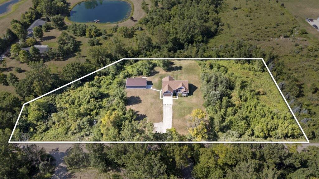 Aerial drone photograph of a vacant lot with the property boundary outlined