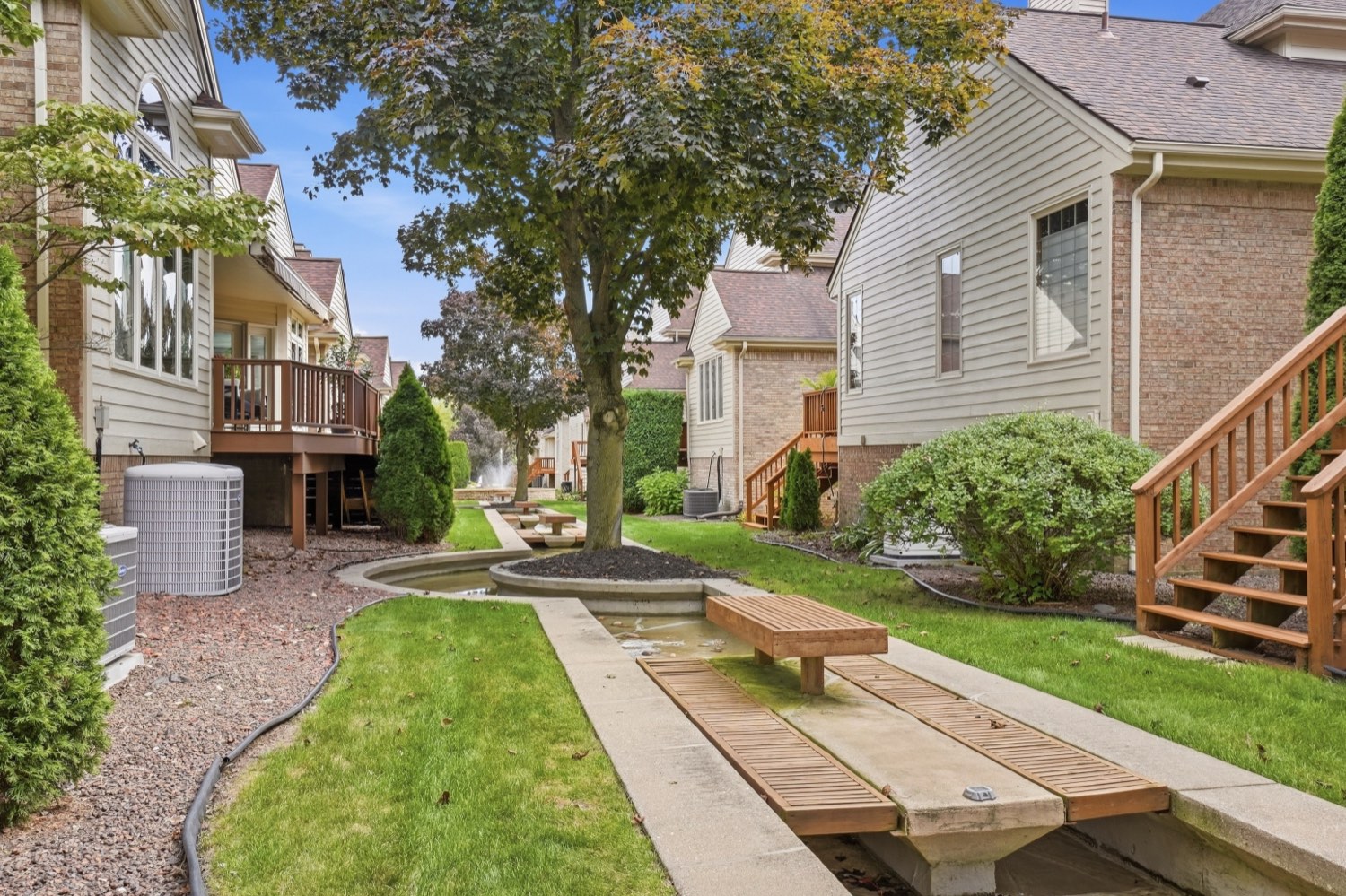 Exterior photograph of a Metro Detroit condominium courtyard in full leaf