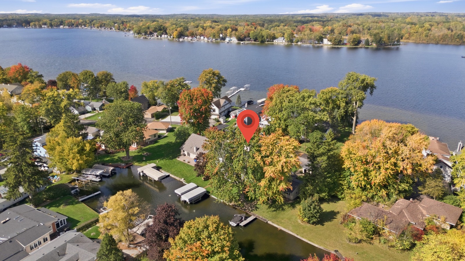 Aerial drone photograph of a lakefront home in autumn