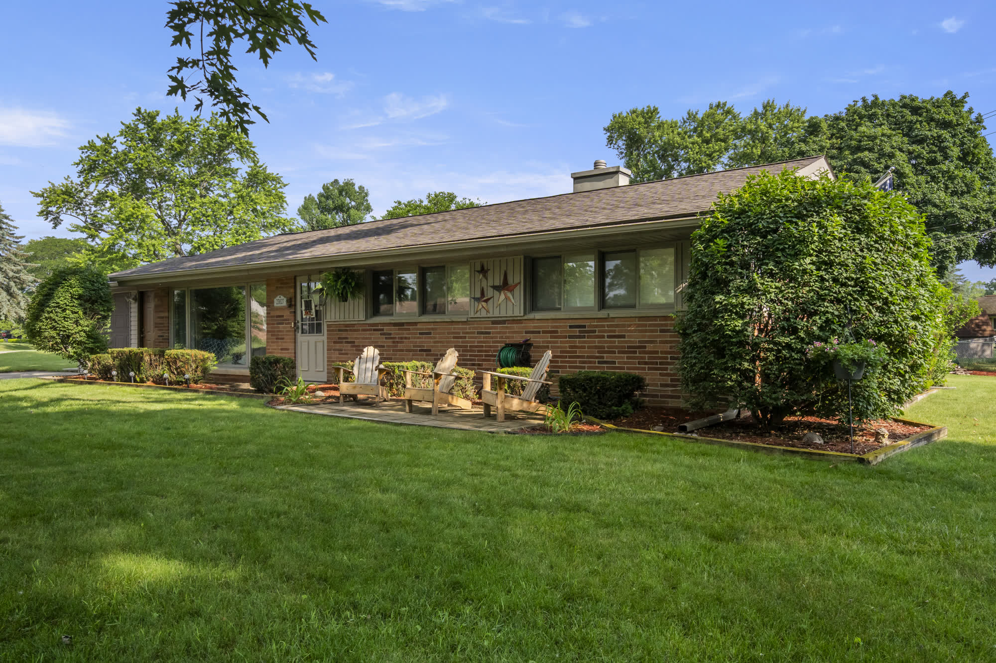 Brick ranch home and front lawn photographed in spring