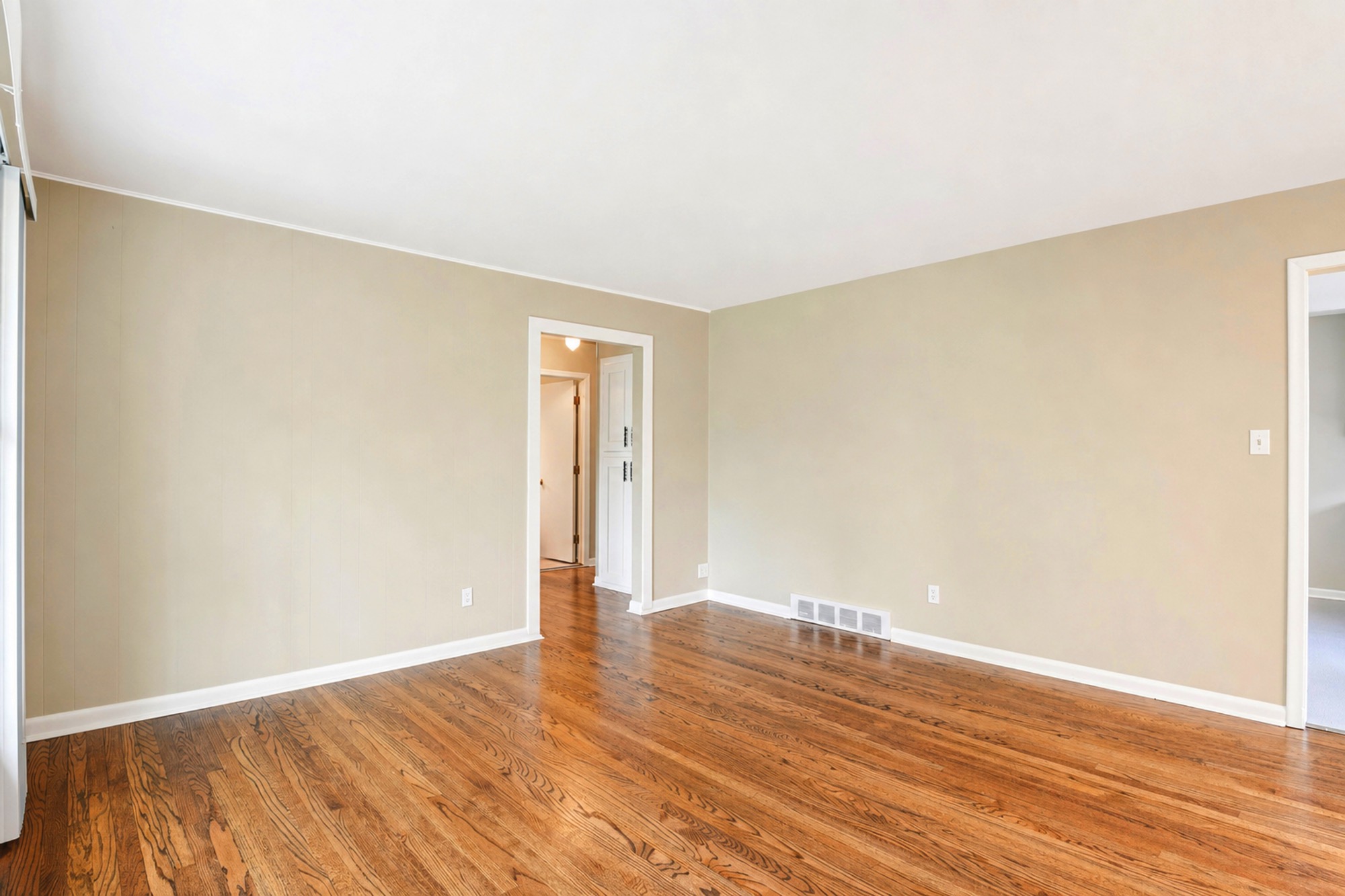 Empty living room with hardwood floors