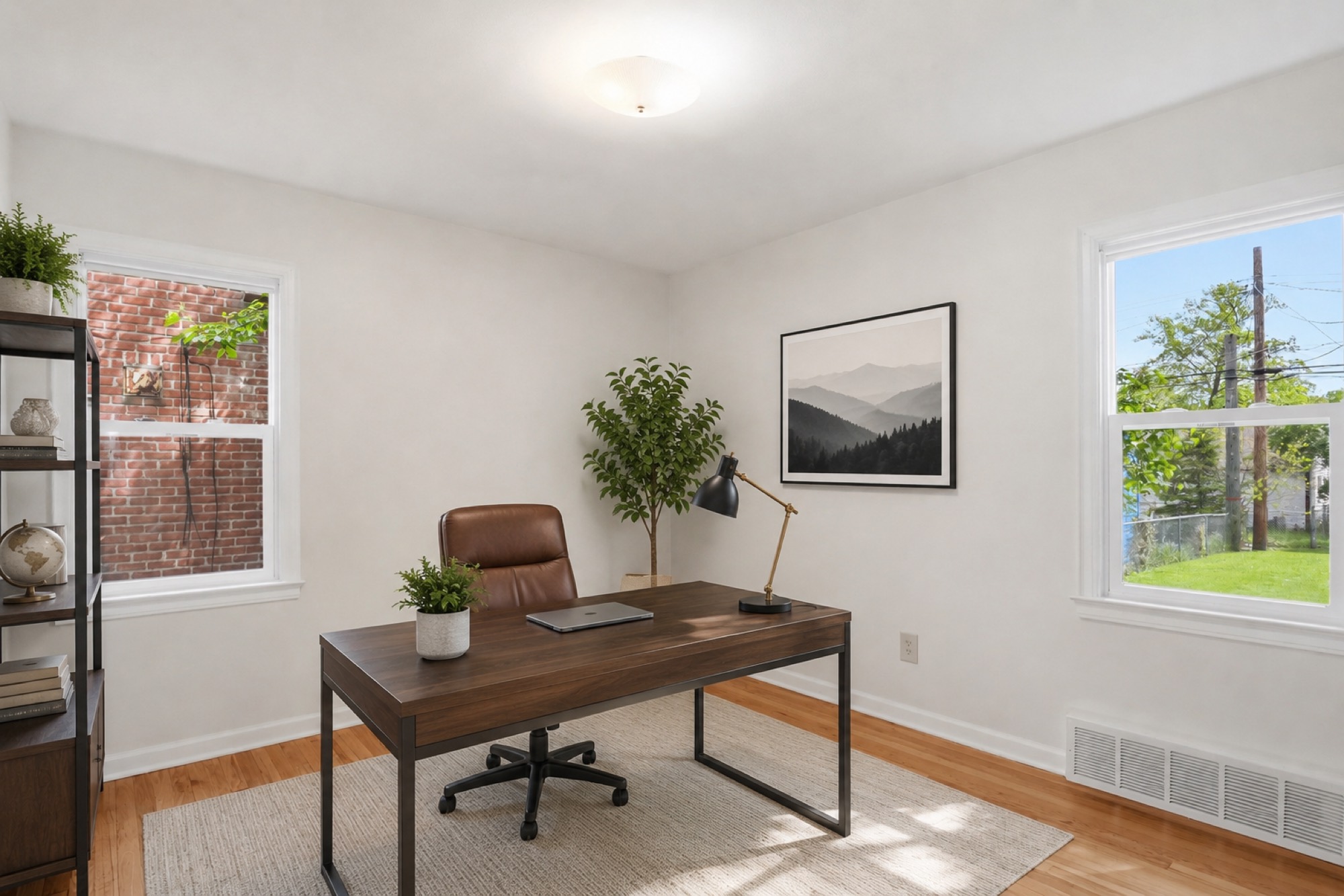The same room virtually staged as a home office with a desk, chair and shelving