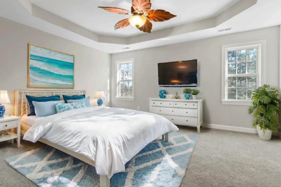 A bedroom virtually staged in a coastal style